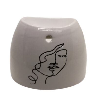 Brûle-parfum blanc avec peinture représentant une femme les yeux fermés en style One Line Drawing